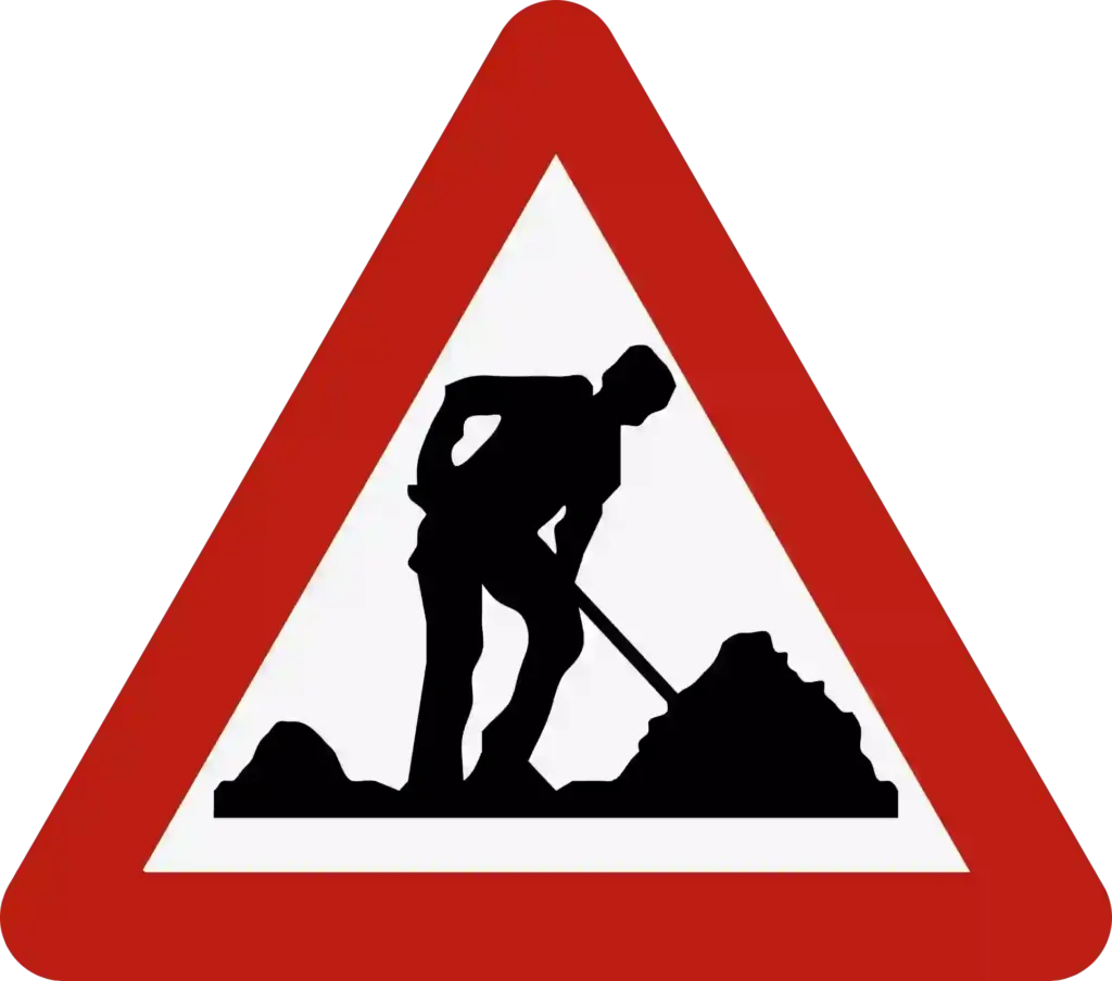 Signal A31 : triangle à bord rouge représentant un ouvrier avec une pelle.