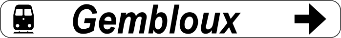Panneau blanc portant « Gembloux », un symbole de train et une flèche noire vers la droite.